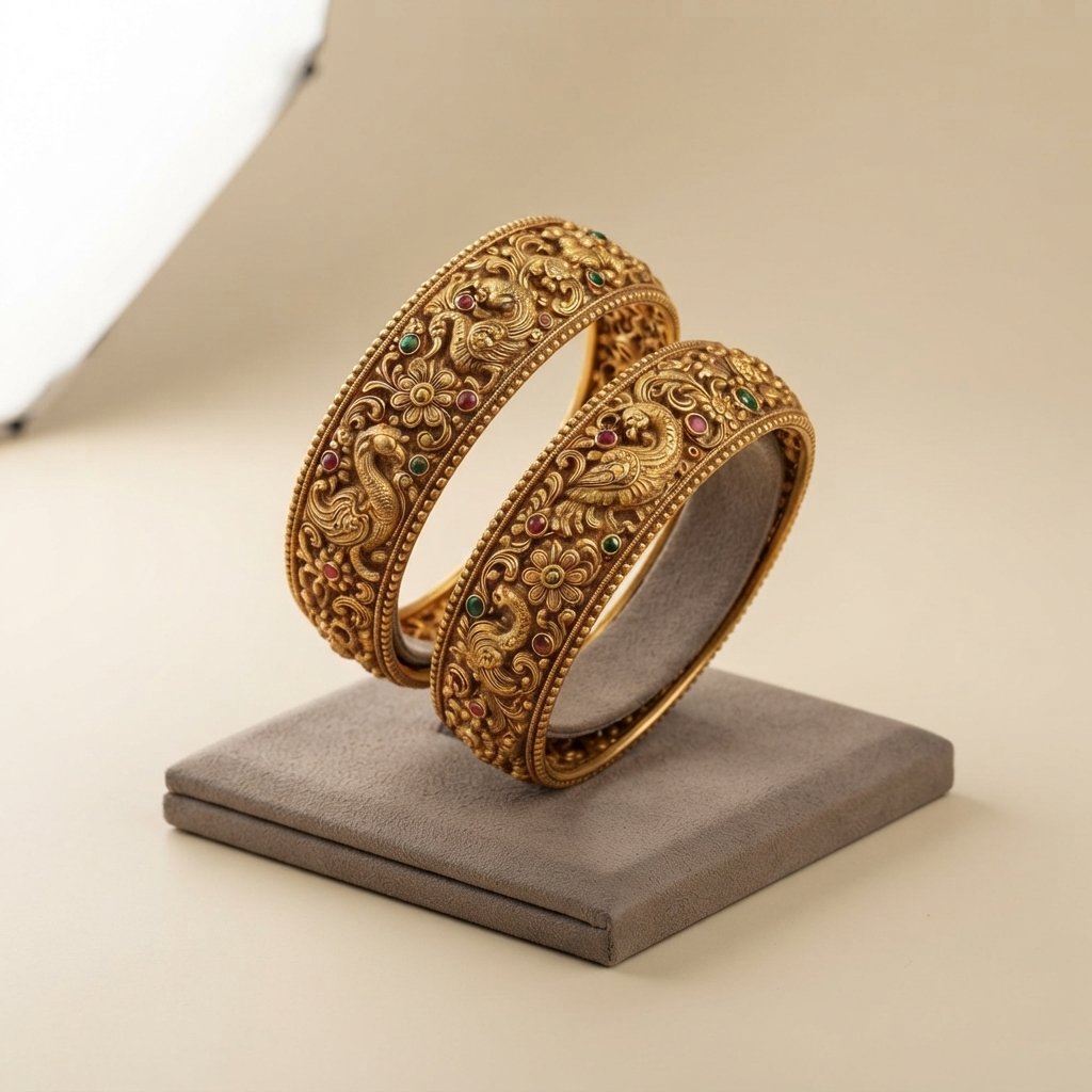 Pair of engraved gold bangles with gemstone detail